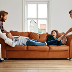 **

*   **Prompt:** A group of friends struggling to move a heavy sofa during a move, emphasizing the concept of inertia. Include elements suggesting a typical Swedish home interior and furniture style.

**